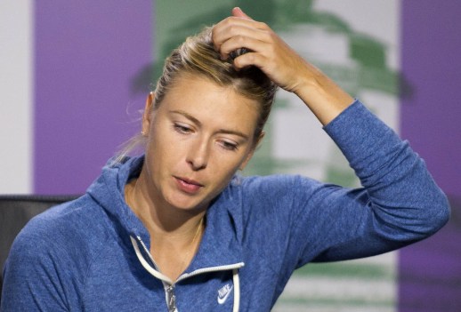 Maria Sharapova of Russia speaks at a news conference after being defeated by Michelle Larcher De Brito of Portugal in their women's singles tennis match at the Wimbledon Tennis Championships, in London