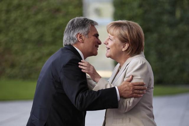 Canciller alemana, Angela Merkel (d), recibe al jefe del Gobierno austríaco, el socialdemócrata Werner Faymann, antes del inicio de una conferencia sobre los Balcanes occidentales. EFE