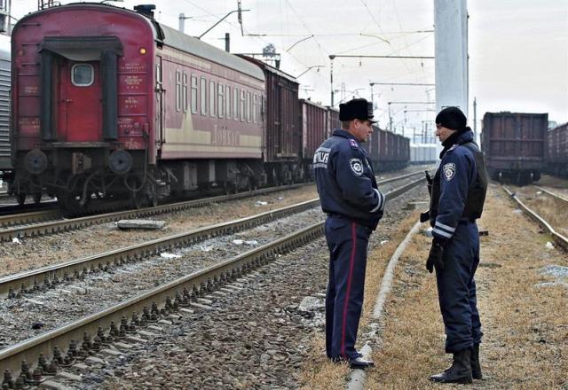 Dos policías hacen guardia junto al tren que transporta los restos del Boeing 777 de Malaysia Airlines abatido en el este de Ucrania en la estación de Járkov (Ucrania) (Foto EFE / Sergei Kozlov)