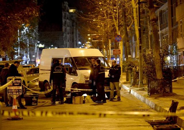 Agentes de policía turcos examinan el escenario de un tiroteo con dos muertos en el barrio de Nisantasi, Estambul (Turquía), hoy, 25 de diciembre de 2014. Los nombres de las víctimas corresponden a Vedat Sahin, hermano del líder de una banda criminal turca, y su amigo Ferdi Topal, según informaron fuentes policiales. EFE/Islam Yakut  