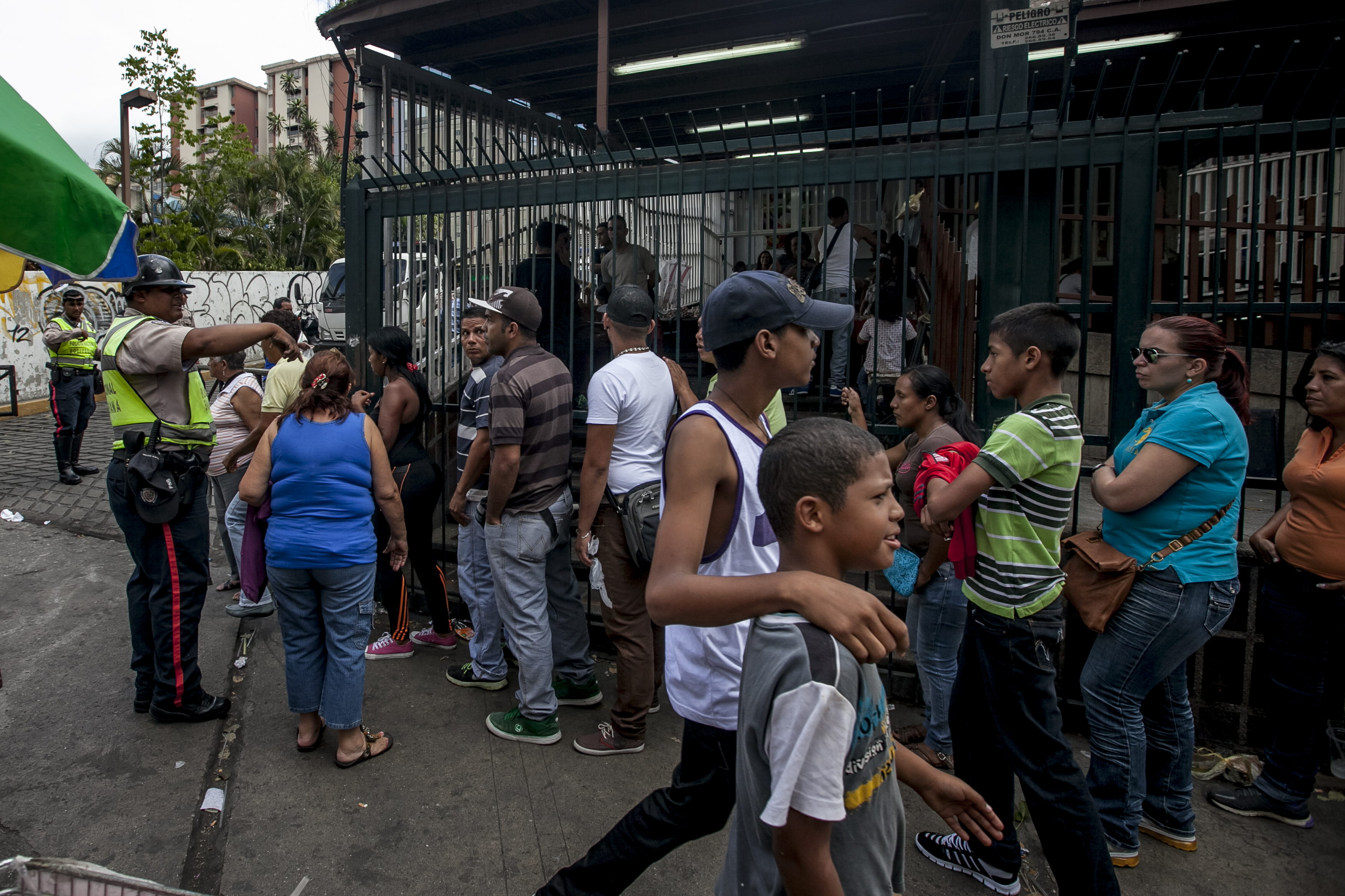 Niños y adolescentes también hacen cola para comprar alimentos