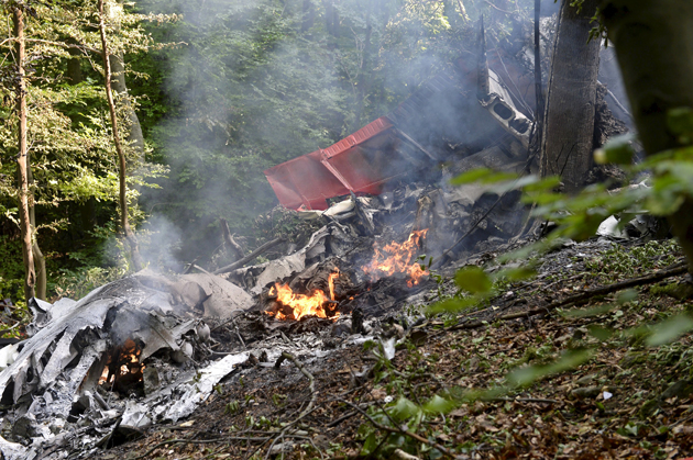 Debris of two sport planes is seen near the village of Cerveny Kamen, Slovakia, August 20, 2015. The death toll from the mid-air collision between the two sport planes over western Slovakia has risen to seven, according to a fire department spokesman.  REUTERS/Radovan Stoklasa