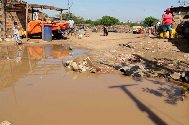 Fotografía del 27 de agosto de 2015 del patio de una casa en un barrio pobre de Asunción (Paraguay). Los habitantes de los humildes barrios a orillas del río Paraguay en Asunción, que el papa Francisco visitó el pasado 12 de julio, denuncian que la zona volvió al abandono en que estaba sumida antes de su llegada y que continúa a merced de la crecida de las aguas. EFE/Andrés Cristaldo Benítez