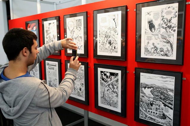 Un visitante fotografía la exposición "Mangas Nucleares", que el Salón del Manga de Barcelona, inaugurado hoy, dedica a los bombardeos atómicos de Hiroshima y Nagasaki, tras abrir sus puertas con las entradas agotadas para el fin de semana. EFE/Alejandro García