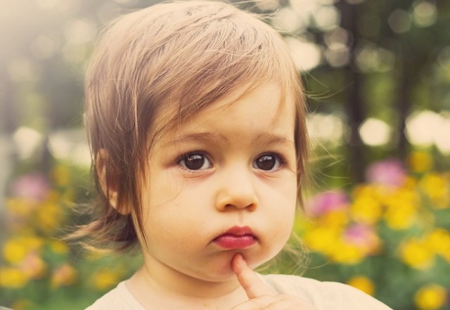 Toned portrait of Cute child thinking outdoor