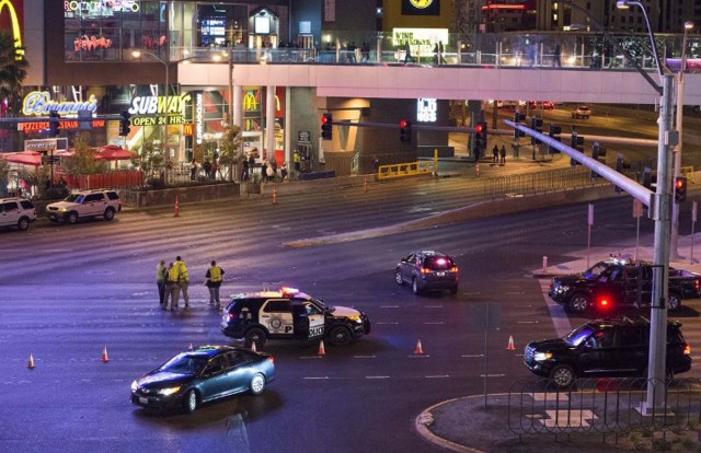 Police and local officials investigate a part of the Las Vegas Strip after a car ran into a group of pedestrians between Planet Hollywood, where the Miss Universe pageant took place, and the Paris Las Vegas Hotel in Las Vegas, Nevada, on December 20, 2015. At least one person has died and more than 37 have been hurt after a car ran into a group of pedestrians on the bustling Las Vegas Strip on December 20, police said, adding the driver was in custody.     AFP PHOTO / VALERIE MACON / AFP / VALERIE MACON