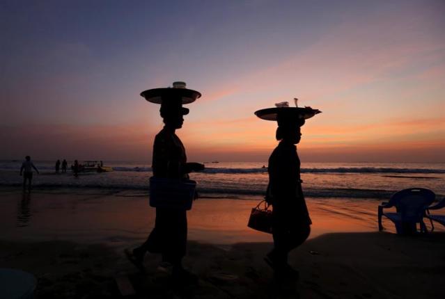 Vendedores ambulantes de aperitivos recorren la playa de Ngwe Saung, también conocida como la playa de Arenas Plateadas, cerca de la localidad de Ngwe Saung, a unos 260 kilómetros de Rangún, en la provinica de Pathein (Birmania) hoy, 21 de diciembre de 2015. Los datos facilitados por el ministerio de Hoteles y Turismo de Birmania señalan que el país ha alojado a más de 3,5 millones de turistas lo que ha supuesto unos ingresos de 1.140 millones de dólares en 2014. El número de turistas ha crecido desde que el país comenzó a abrirse al exterior tras las elecciones de 2010 que acabaron con el gobierno de la Junta Militar. Las autoridades predijeron la llegada de unos cinco millones de turistas en 2015 y el ministerio planea abrir más zonas costeras y regiones étnicas nuevas que se añadirían a los destinos ya populares. Birmania prevé que en 2020 la cifra de turistas alcance los 7,5 millones. EFE/Nyein Chan Naing