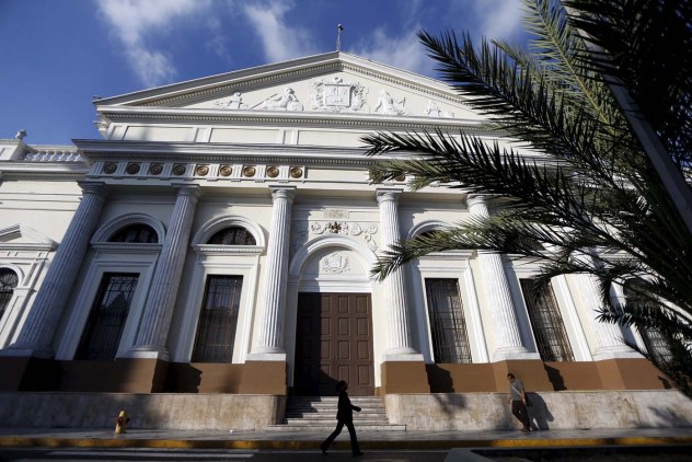 People walk past the National Assembly building during a parliamentary session in Caracas January 19, 2016. REUTERS/Carlos Garcia Rawlins