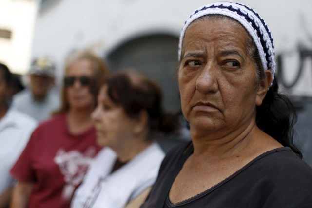 A woman waits next to others in a line for the elderly outside a PDVAL, a state-run supermarket, to buy chicken in Caracas January 22, 2016. Venezuela's opposition refused on Friday to approve President Nicolas Maduro's "economic emergency" decree in Congress, saying it offered no solutions for the OPEC nation's increasingly disastrous recession. Underlining the grave situation in Venezuela, where a plunge in oil prices has compounded dysfunctional policies, the International Monetary Fund on Friday forecast an 8 percent drop in gross domestic product and 720 percent inflation this year. REUTERS/Carlos Garcia Rawlins