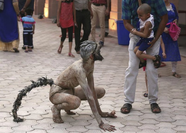 Un niño llora al contemplar la actuación de un artista indio disfrazado de mono durante el Festival del Patrimonio en Amritsar (India) hoy, 9 de mayo de 2016. Las actuaciones culturales de artistas procedentes de diferentes estados suponen uno de los principales atractivos de este festival indio. EFE/Raminder Pal Singh