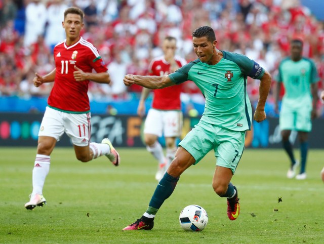 Football Soccer - Hungary v Portugal - EURO 2016 - Group F - Stade de Lyon, Lyon, France - 22/6/16 Portugal's Cristiano Ronaldo in action with Hungary's Krisztian Nemeth REUTERS/Kai Pfaffenbach Livepic