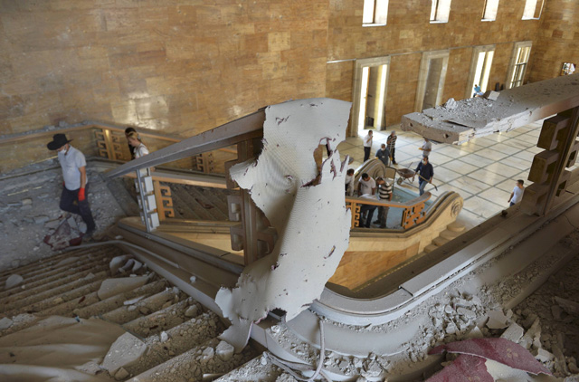 People walk inside the damaged parliament building in Ankara, Turkey, July 16, 2016. REUTERS/Stringer EDITORIAL USE ONLY. NO RESALES. NO ARCHIVES.