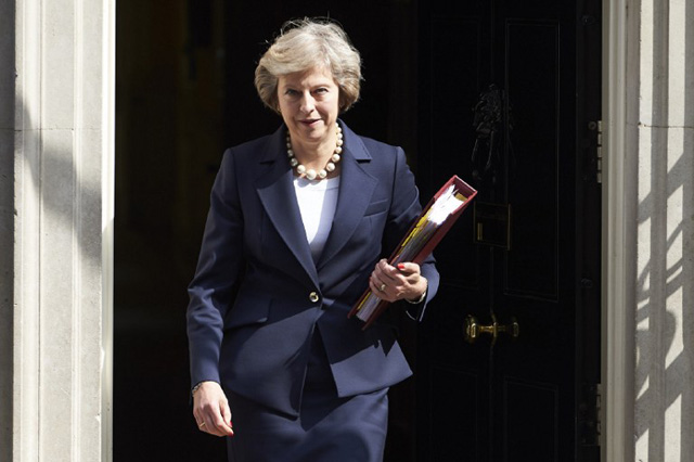 British Prime Minister Theresa May leaves 10 Downing street in London on July 20, 2016 on her way to the House of Commons to face her first session of Prime Ministers Questions. British Prime Minister Theresa May meets European leaders for later today to start thrashing out the roadmap for her country's exit from the European Union. / AFP PHOTO / NIKLAS HALLE'N