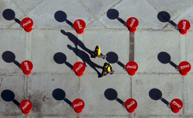 2016 Rio Olympics - Olympic Park - Rio de Janeiro, Brazil - 31/07/2016. Volunteers walk between Coca Cola branded tables near the main press centre and broadcast centre. REUTERS/Kevin Coombs TPX IMAGES OF THE DAY