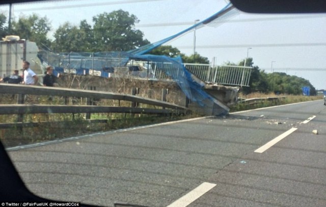 379FF8FD00000578-3761261-Pictured_The_pedestrian_bridge_crushes_a_safety_fence_as_collaps-a-60_1472302178280