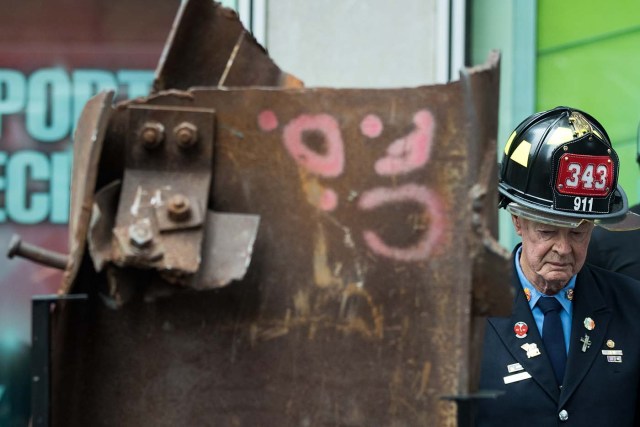 NEW YORK, NY - SEPTEMBER 6: Bob Beckwith, retired firefighter who stood next to President George W. Bush at ground zero, stands next to a piece of steel from the World Trade Center, during a ceremony outside the Fox News studios to mark the beginning of the piece of steel's journey from New York City to Gander, Newfoundland in Canada, September 6, 2016 in New York City. Following the 9/11 attacks, 40 planes were grounded in the small town of Gander. In the following days, residents of Gander helped care for the nearly 6,000 people who were stranded. Drew Angerer/Getty Images/AFP