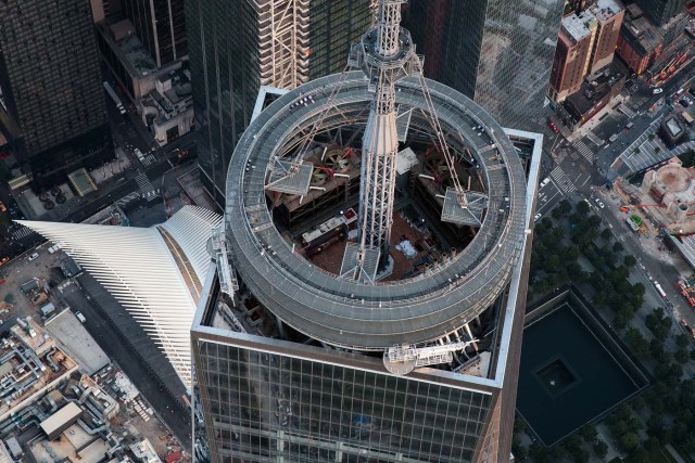 NEW YORK, NY - SEPTEMBER 8: (L to R) An aerial view the Oculus Transportation Hub, the top of One World Trade Center and one of the September 11 Memorial pools, in Lower Manhattan, September 8, 2016 in New York City. New York City is preparing to mark the 15th anniversary of the September 11 terrorist attacks.   Drew Angerer/Getty Images/AFP