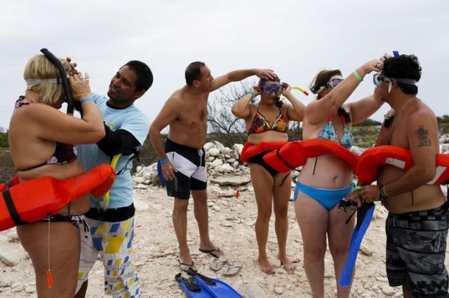 Turistas argentinos antes de comenzar una clase de buceo en Los Roques, Venezuela, mayo 29, 2015. Desde que su gobierno monopolizó el acceso a los dólares en el 2003, el fallecido presidente Hugo Chávez repitió en varias oportunidades que el control de cambios "llegó para quedarse". REUTERS/Carlos Garcia Rawlins