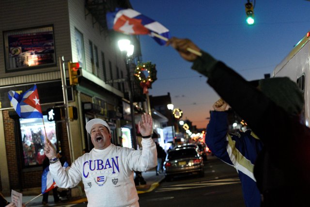 People wave Cuban flags and shout "Viva Cuba!" while celebrating the news of the death of  Cuban revolutionary leader Fidel Castro in Union City, New Jersey