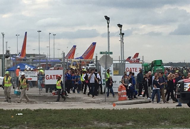 Travelers and airport workers are evacuated out of the terminal after airport shooting at Fort Lauderdale-Hollywood International Airport in Florida, U.S., January 6, 2017.   REUTERS/Andrew Innerarity