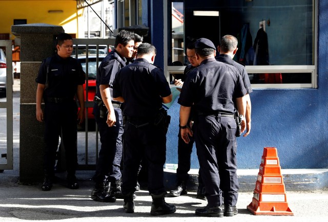 Police officers gather outside the morgue at Kuala Lumpur General Hospital where Kim Jong Nam's body is held for autopsy in Malaysia February 16, 2017. REUTERS/Edgar Su