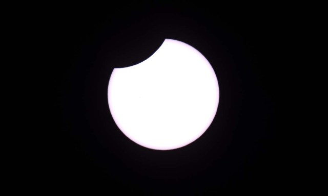 Picture taken on February 26, 2017 showing the moon moving to cover the sun for an annular solar eclipse, as seen from the Estancia El Muster, near Sarmiento, Chubut province, 1600 km south of Buenos Aires, Argentina, on February 26, 2017. Stargazers applauded as they were plunged into darkness Sunday when the moon passed in front of the sun in a spectacular "ring of fire" eclipse. / AFP PHOTO / ALEJANDRO PAGNI