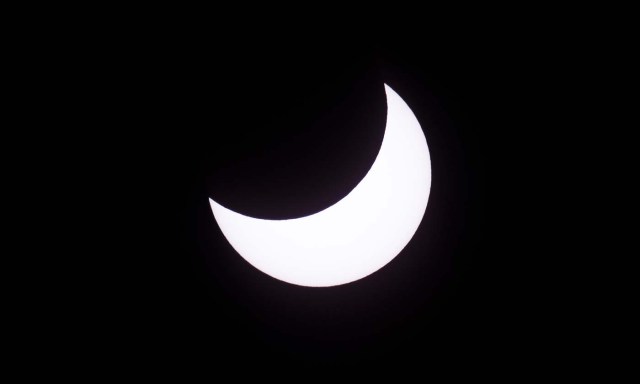 Picture taken on February 26, 2017 showing the moon moving to cover the sun for an annular solar eclipse, as seen from the Estancia El Muster, near Sarmiento, Chubut province, 1600 km south of Buenos Aires, Argentina, on February 26, 2017. Stargazers applauded as they were plunged into darkness Sunday when the moon passed in front of the sun in a spectacular "ring of fire" eclipse. / AFP PHOTO / ALEJANDRO PAGNI