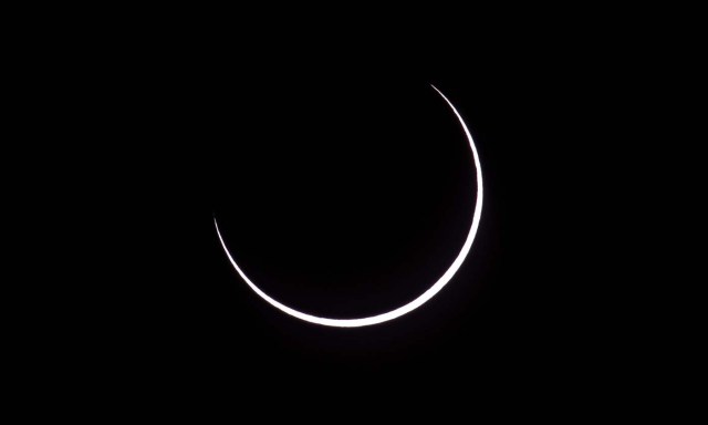 Picture taken on February 26, 2017 showing the moon moving to cover the sun for an annular solar eclipse, as seen from the Estancia El Muster, near Sarmiento, Chubut province, 1600 km south of Buenos Aires, Argentina, on February 26, 2017. Stargazers applauded as they were plunged into darkness Sunday when the moon passed in front of the sun in a spectacular "ring of fire" eclipse. / AFP PHOTO / ALEJANDRO PAGNI