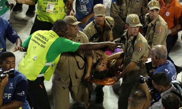 A reveller is assisted after an accident with a float from Unidos da Tijuca samba school during the second night of the carnival parade at the Sambadrome in Rio de Janeiro, Brazil, February 28, 2017. REUTERS/Pilar Olivares