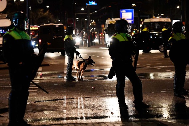 Riot police stand guard during clashes with demonstrators in the streets near the Turkish consulate in Rotterdam, Netherlands March 12, 2017. REUTERS/Dylan Martinez