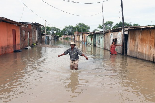  Un poblador trata de cruzar una calle inundada hoy, martes 14 de marzo del 2017, por las lluvias torrenciales caídas sobre el sector de El Indio, en la provincia de Castilla, de la región de Piura en la costa norte de Perú. Varios ministros de Estado visitan hoy la región Piura, al norte de Perú, para hacer una evaluación de los daños y necesidades de la población, tras las inundaciones y deslizamientos de lodo por las intensas lluvias provocadas por un fenómeno del Niño costero. EFE/Elías Agustín