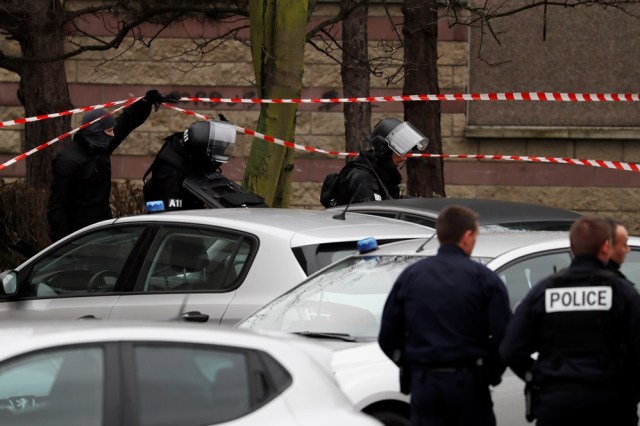 Police officers and RAID police unit officers investigate at the house of the suspect of an attack at the Paris Orly's airport, on March 18, 2017 in Garges-les-Gonesse. A man who had been investigated for links to radical Islam was shot dead at Orly airport south of Paris on today after attacking a soldier on patrol and trying to grab her rifle. The same man is suspected of having shot at police earlier in the day, leaving an officer with minor wounds after being pulled over while driving in a suburb north of the French capital.  / AFP PHOTO / THOMAS SAMSON