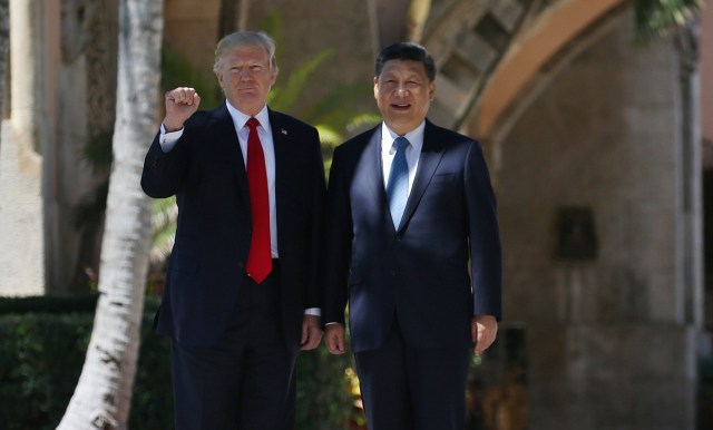 U.S. President Donald Trump and China's President Xi Jinping are seen during a walk along the front patio of the Mar-a-Lago estate after a bilateral meeting in Palm Beach, Florida, U.S., April 7, 2017. REUTERS/Carlos Barria