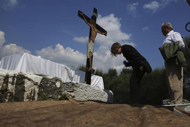 Varios fieles hacen cola para besar un crucifijo durante el ritual Apokathelosis, de recreación de la bajada de Jesús de la cruz, en la iglesia del monasterio Pendeli en Atenas (Grecia) hoy, 14 de abril de 2017. EFE/Alexandros Vlachos