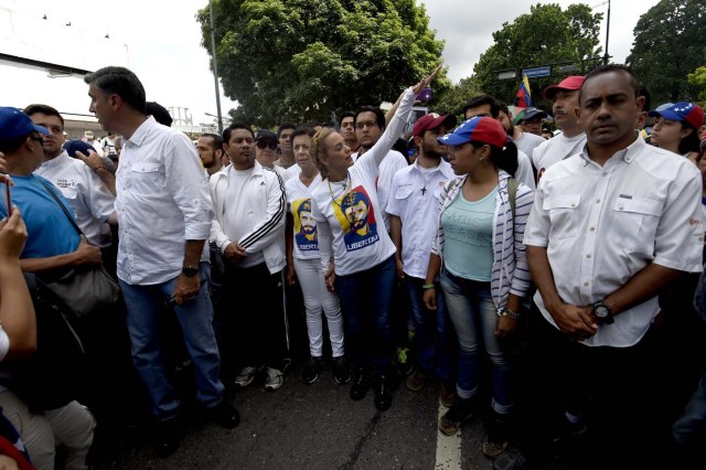 Lilian Tintori (C), wife of jailed Venezuelan opposition leader Leopoldo Lopez, prepares to take part in a march towards the Catholic Church's episcopal seats nationwide, in Caracas, on April 22, 2017. Venezuelans gathered Saturday for "silent marches" against President Nicolas Maduro, a test of his government's tolerance for peaceful protests after three weeks of violent unrest that has left 20 people dead. / AFP PHOTO / JUAN BARRETO