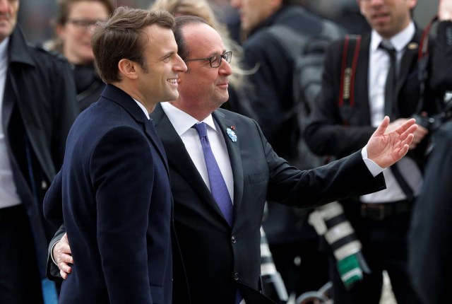 Outgoing French President Francois Hollande (R) and President-elect Emmanuel Macron attend a ceremony to mark the end of World War II at the Tomb of the Unknown Soldier at the Arc de Triomphe in Paris, France, May 8, 2017. REUTERS/Philippe Wojazer TPX IMAGES OF THE DAY