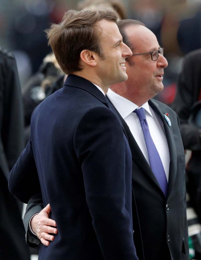 Outgoing French President Francois Hollande (R) and President-elect Emmanuel Macron attend a ceremony to mark the end of World War II at the Tomb of the Unknown Soldier at the Arc de Triomphe in Paris, France, May 8, 2017. REUTERS/Philippe Wojazer