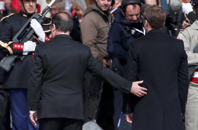 Outgoing French President Francois Hollande (L) and President-elect Emmanuel Macron attend a ceremony to mark the end of World War II at the Tomb of the Unknown Soldier at the Arc de Triomphe in Paris, France, May 8, 2017. REUTERS/Benoit Tessier TPX IMAGES OF THE DAY