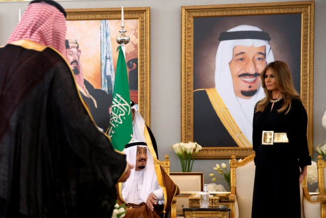 U.S. first lady Melania Trump (R) takes her seat next to Saudi Arabia's King Salman bin Abdulaziz Al Saud (seated-L) as he welcomes her and U.S. President Donald Trump (not pictured) with a coffee ceremony in the Royal Terminal after they arrived aboard Air Force One at King Khalid International Airport in Riyadh, Saudi Arabia May 20, 2017. REUTERS/Jonathan Ernst