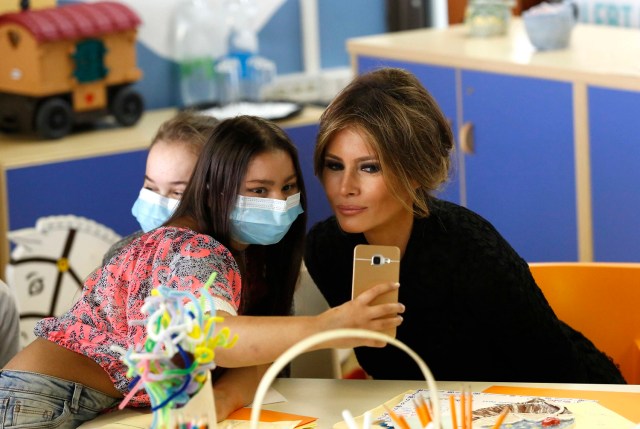 A girl takes a selfie with U.S. first lady Melania Trump at the Bambino Gesu hospital in Rome, Italy, May 24, 2017. REUTERS/Remo Casilli