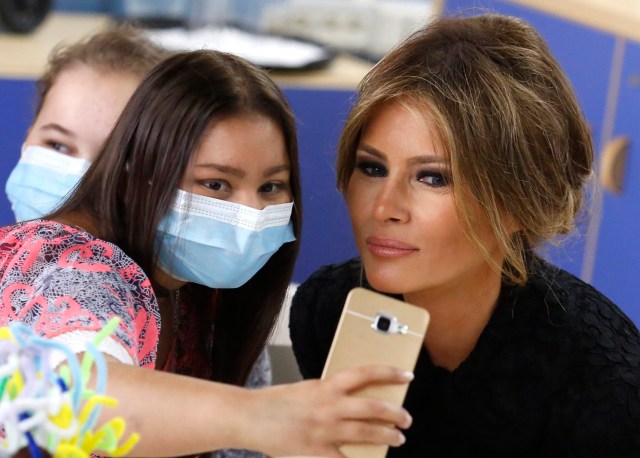 A girl takes a selfie with U.S. first lady Melania Trump at the Bambino Gesu hospital in Rome, Italy, May 24, 2017. REUTERS/Remo Casilli