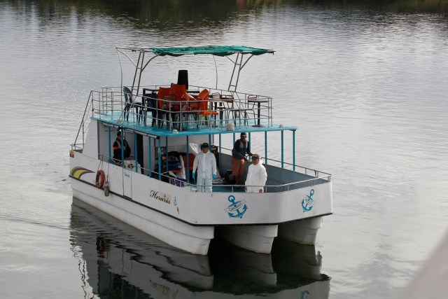 Forensic technicians stand on a boat as the search for people believed to be missing after a tourist boat sank on Sunday continues, in Guatape, Colombia June 26, 2017. REUTERS/Fredy Builes