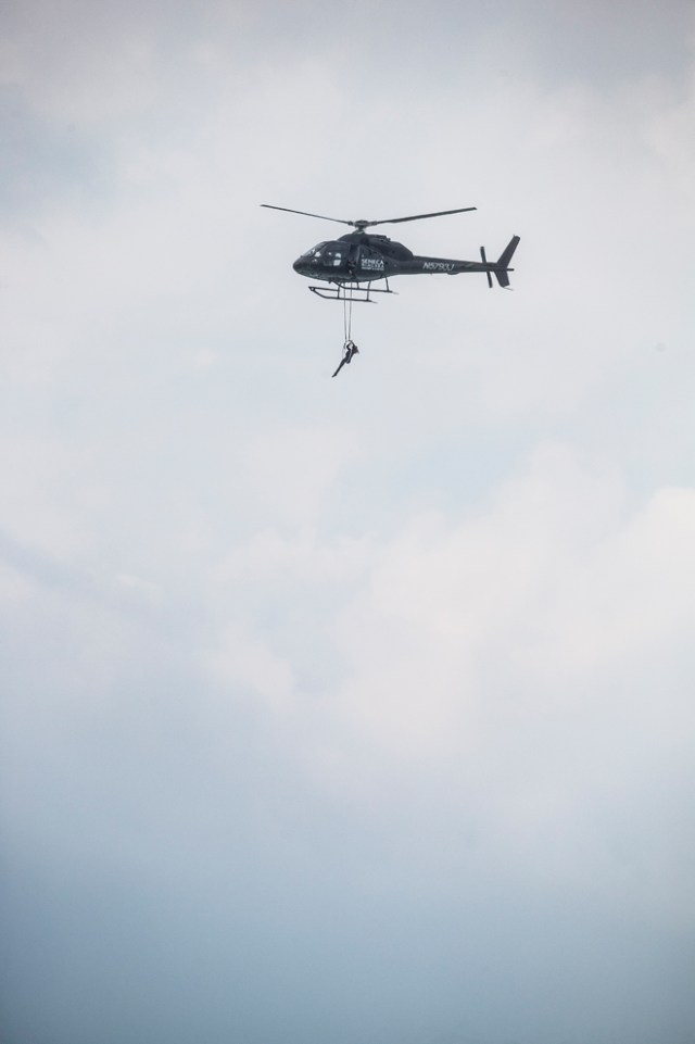 Aerialist Erendira Wallenda hangs beneath a helicopter during a stunt over the Horseshoe Falls at Niagara Falls, New York, June 15, 2017. / AFP PHOTO / Geoff Robins