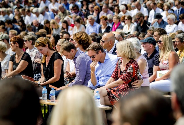 Relatives attend the unveiling of the National Monument for the MH17 victims in Vijfhuizen, on July 17, 2017. Three years after Flight MH17 was shot down by a missile over war-torn Ukraine, more than 2,000 relatives gather to unveil a "living memorial" to their loved ones. A total of 298 trees have been planted in the shape of a green ribbon, one for each of the victims who died on board the Malaysia Airlines flight en route from Amsterdam to Kuala Lumpur. / AFP PHOTO / ANP / Remko de Waal / Netherlands OUT