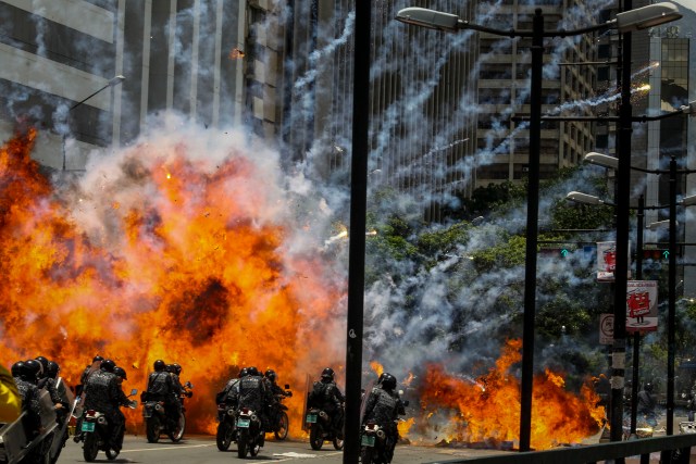 Fotografía de una explosión en medio de varios policías motorizados hoy, domingo 30 de julio de 2017, en inmediaciones de la Plaza Altamira de Caracas (Venezuela). Un agente resultó hoy herido tras la explosión de dos motos de la Policía Nacional Bolivariana (PNB) y otra de un civil, en las inmediaciones de una protesta ciudadana en Caracas contra las elecciones a la Asamblea Nacional Constituyente, convocada por el presidente venezolano, Nicolás Maduro. EFE/Miguel Gutiérrez