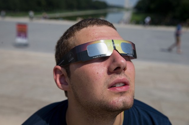 WASHINGTON, DC - AUGUST 21: People gather at the Lincoln Memorial to watch the solar eclipse on August 21, 2017 in Washington, DC. Millions of people have flocked to areas of the U.S. that are in the "path of totality" in order to experience a total solar eclipse. During the event, the moon will pass in between the sun and the Earth, appearing to block the sun. During the eclipse, Washington D.C. residents will see the moon cover 81 percent of the sun at its peak. Tasos Katopodis/Getty Images/AFP