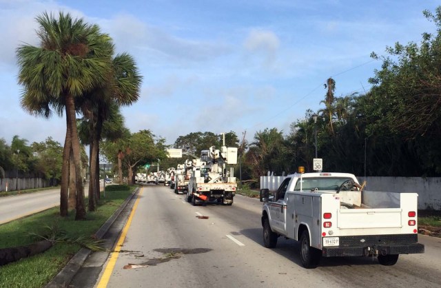 A convoy of electric utility trucks moves through North Miami after the passage of Hurricane Irma on September 11, 2017. Irma weakened early Monday to a tropical storm as it continued on a northward path through Florida, the National Hurricane Center said. As of 8 am (1200 GMT), Irma was about 105 miles (170 kilometers) northwest of Tampa, with maximum sustained winds of 70 miles per hour (110 kilometers per hour). Early reports of Irma's aftermath seemed to show that damage in Florida from the massive storm were not as bad as initially feared. / AFP PHOTO / Michele Eve SANDBERG