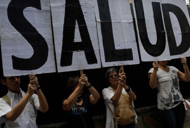 People hold letters which read "Health" during a protest outside the World Health Organization (WHO) office in Caracas, Venezuela September 25, 2017. REUTERS/Ricardo Moraes