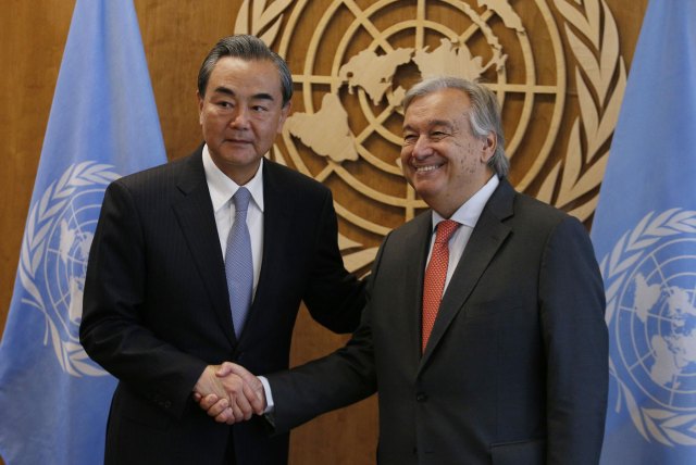 Chinese Foreign Minister Wang Yi (L) shakes hands with United Nations Secretary General Antonio Guterres prior to their meeting at U.N. headquarters in New York, U.S., September 18, 2017. REUTERS/Brendan McDermid