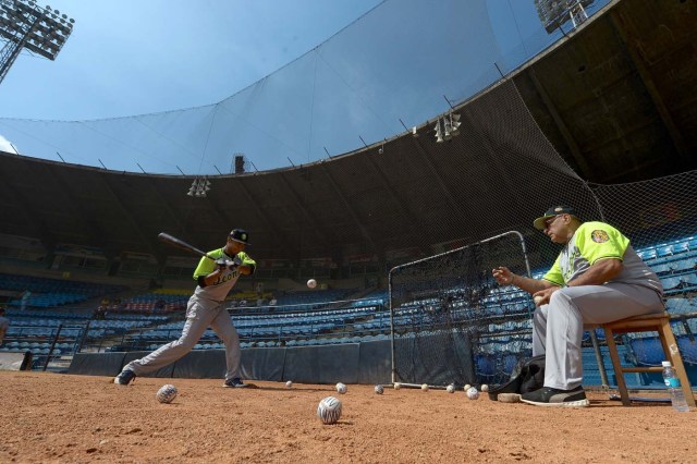 Players of the Venezuelan baseball team Leones del Caracas attend a training session at the Universitario stadium in Caracas, on September 18, 2017. While baseball is Venezuela's national sport, some fans are angry that the government, given the severity of the economic crisis and the political tension, will spend nearly ten million dollars on organizing the upcoming Winter League rather than on imports of food and medicine. / AFP PHOTO / FEDERICO PARRA